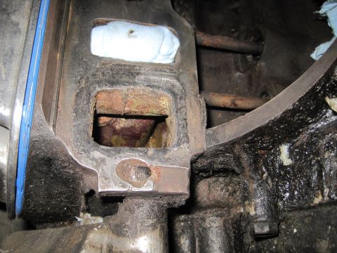 1989 Ford Bronco - Engine part showing rust and blue gasket material, likely during reassembly.