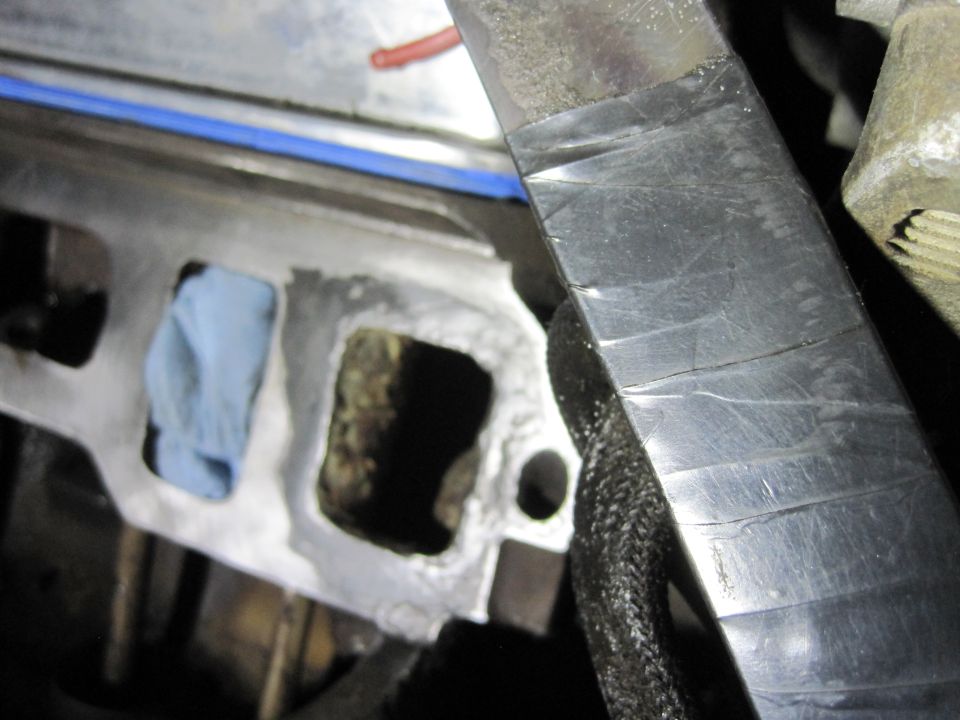 Engine intake manifold with blue tape and a blue rag stuffed in one port