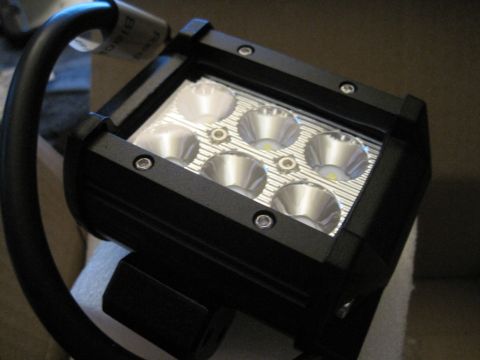 1989 Ford Bronco - A close-up view of a black LED light bar, showing its construction and reflective elements.