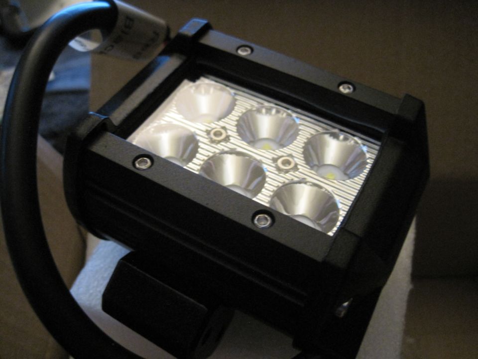 Black LED light bar with six circular reflectors and a black cable attached