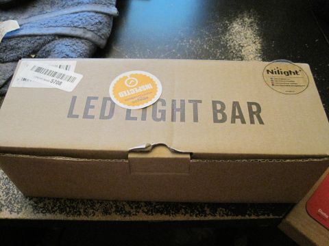 1989 Ford Bronco - Cardboard box containing an LED light bar, with inspection stickers visible.