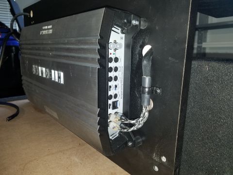 1994 Ford Bronco - A car amplifier is shown mounted to a panel, with its input and output connections visible.