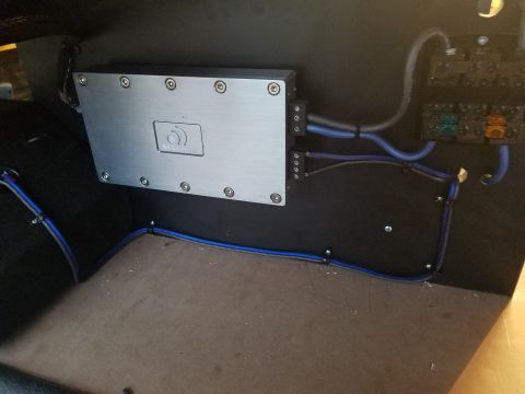 1994 Ford Bronco - A car stereo amplifier and fuse box are installed in the interior of a vehicle.