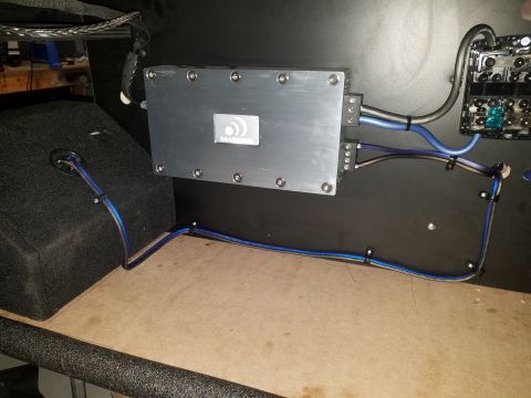 1994 Ford Bronco - Custom car audio installation an amplifier, subwoofer, and fuse box with visible wiring.