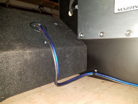 1994 Ford Bronco - Close-up of car audio equipment, showing an amplifier and a subwoofer box with wiring.