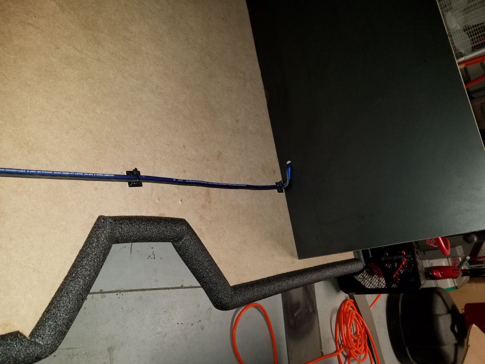 Insulated pipe and blue wiring secured with clips