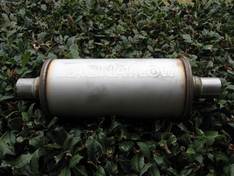 1987 Jaguar XJ6 - A Magnaflow exhaust muffler is shown against a backdrop of green leaves.