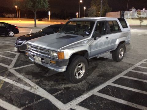 1985 Jaguar XJ6 - This Toyota 4Runner, likely a 1984 model, is parked in a lot at night.
