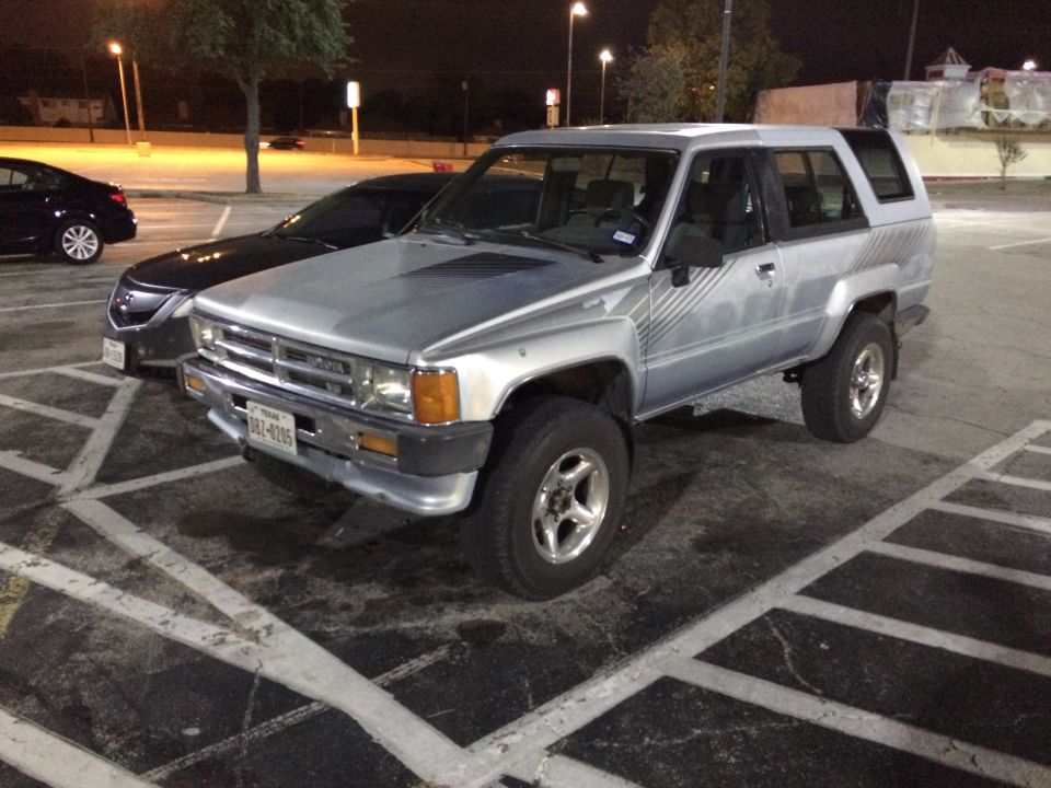 Silver 1984 Toyota 4Runner with a cap, front 3/4 view