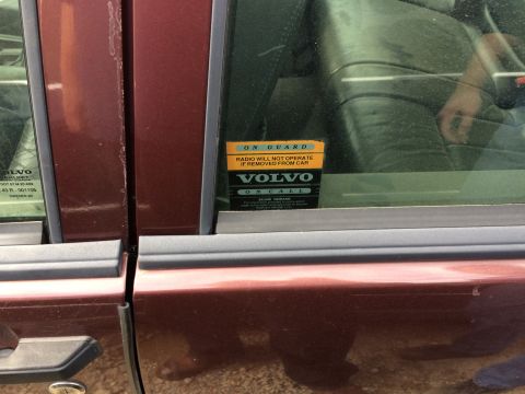 1985 Jaguar XJ6 - A Volvo On Call sticker is visible on the window of a maroon vehicle.