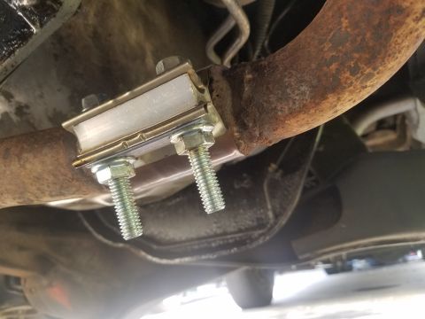 1984 Ford Bronco - Close-up view of a vehicle's exhaust system, focusing on a newly installed hanger.