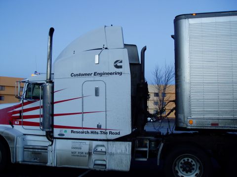 2011 Harley-Davidson Elec Gld Police - A semi-truck with a trailer is parked under a blue sky. The truck has "Customer Engineering" written on its side.