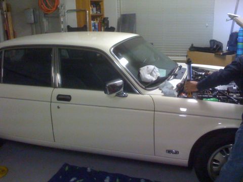 1987 Jaguar XJ6 - A white 1987 Jaguar XJ6 is shown with its hood open, revealing the engine bay.