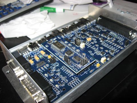 1987 Jaguar XJ6 - An electronic circuit board with multiple integrated circuits and surface-mount components is visible within a metal enclosure.