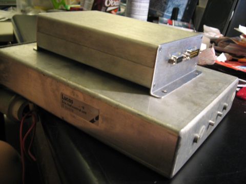 1987 Jaguar XJ6 - Two stacked aluminum electronic control units are visible, with the lower unit a label identifying it as a Lucas Fuel Control Unit.