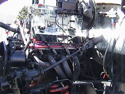 1995 Ford Bronco - Close-up view of a modified engine, showing exhaust headers and various components.