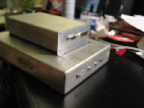 1987 Jaguar XJ6 - Two electronic enclosures are stacked, one on top of the other, on a dark surface.