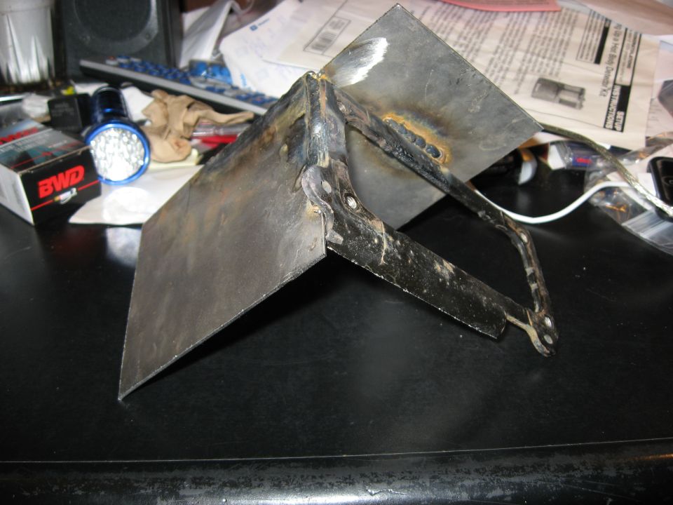 Welded metal bracket with two angled plates and a frame