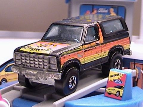 1979 Ford Bronco - Toy 1979 Ford Bronco with custom paint job on display.