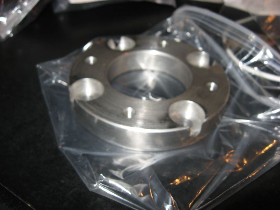 Metal part with bolt holes in plastic packaging