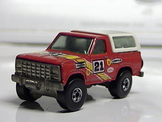 Red die-cast Bronco toy with white top, No. 21 racing decals and chrome brush guard