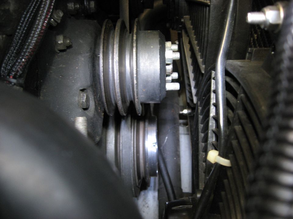 Engine pulleys and fan assembly with black hoses and wiring