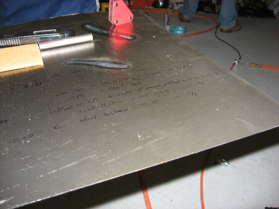 Metal plate with handwritten calculations for CPS, metal thickness, and wheel thickness