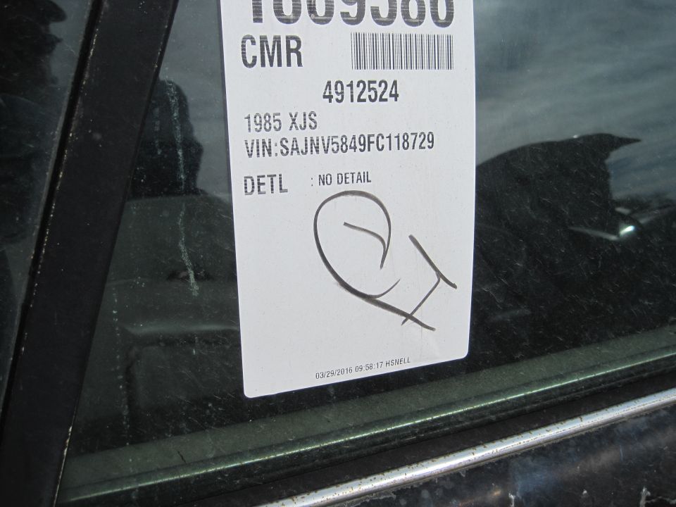 Vehicle information sticker on a car window, showing VIN SAJNV5849FC118729.