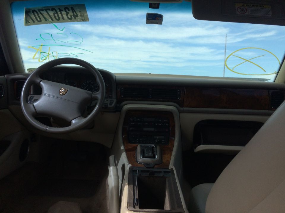 Interior of a Jaguar XJ6 showing the dashboard, steering wheel, and center console.