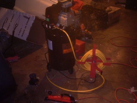 1991 Ford LTD Crown Victoria - An air compressor and various tools are set up in a workshop environment.