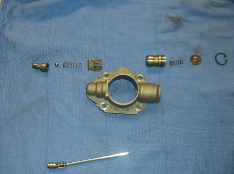 1979 Ford Ranchero - Various components of an oil pump are disassembled and laid out on a blue cloth for inspection or repair.