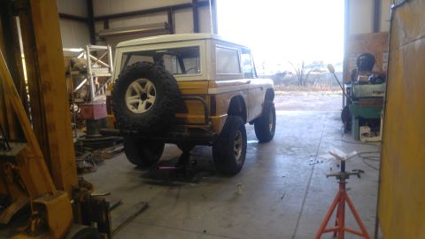 1971 Ford Bronco - Workshop view of a 1971 Ford Bronco, showing its rear end and spare tire.
