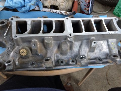 1989 Ford Bronco - An aluminum intake manifold is shown, likely for a V8 engine, with visible casting numbers and ports.