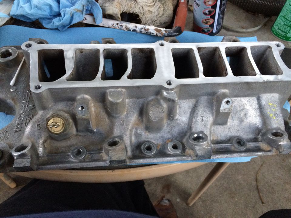 Aluminum intake manifold with visible casting marks and ports