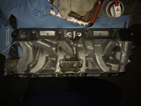 1989 Ford Bronco - An engine intake manifold is shown, likely during a rebuild or maintenance process.
