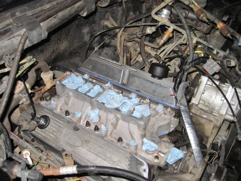 1989 Ford Bronco - Engine bay during a build, with the intake manifold removed to expose the cylinder heads and fuel injectors.