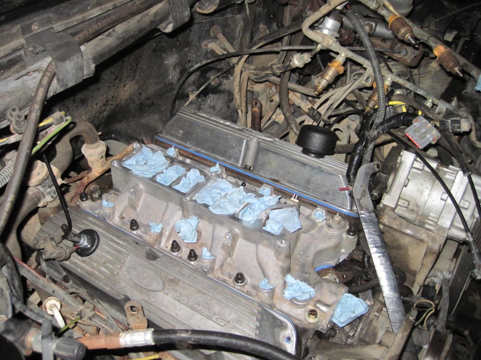 Engine bay with intake manifold removed, showing cylinder heads and fuel injectors