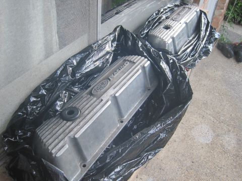 1989 Ford Bronco - Two aluminum Ford Racing valve covers are shown, each wrapped in a black plastic bag.