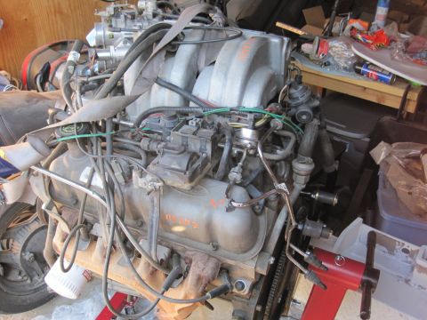 1989 Ford Bronco - Ford V8 engine on a stand, possibly from a 1989 Bronco, with visible orange lettering.