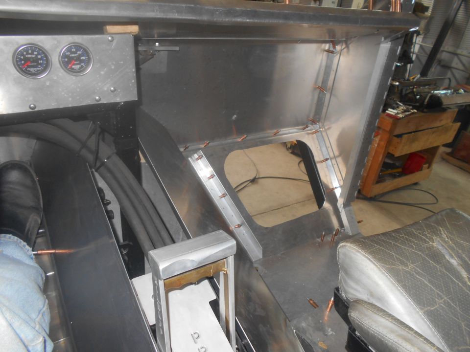 Custom metal fabrication in progress, showing dashboard area with gauges and unfinished console