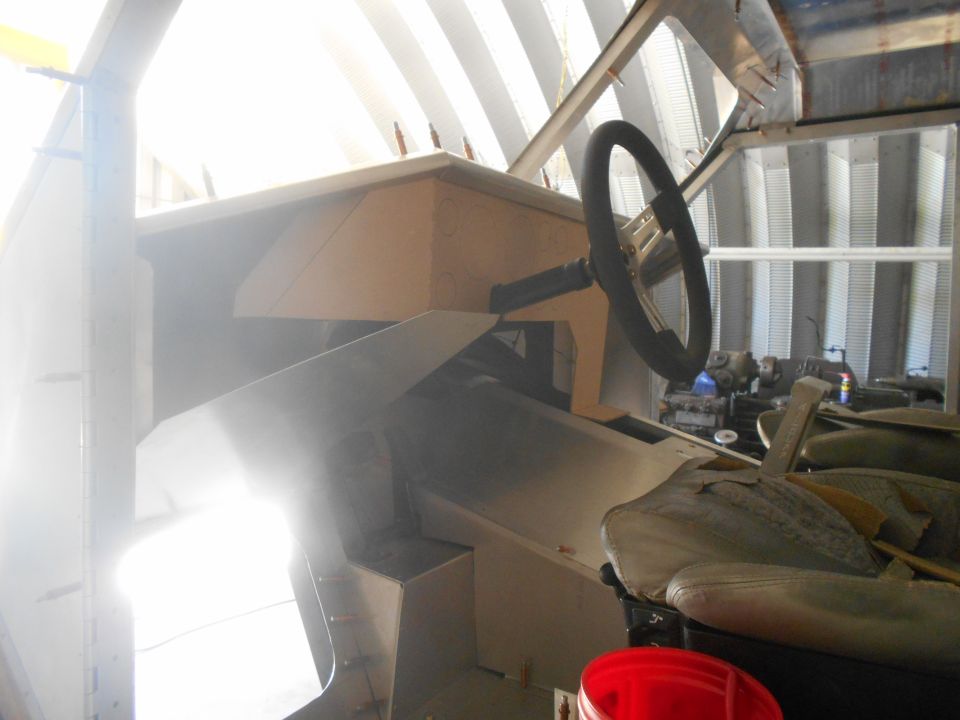 Vehicle interior with a steering wheel, dashboard, and seats, under construction