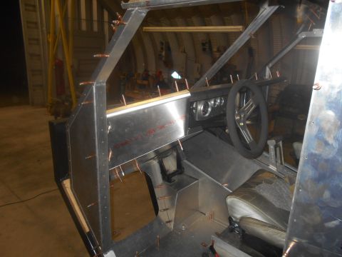1992 Ford Bronco - This custom vehicle interior is still under construction, with bare metal panels and an unfinished dashboard visible.