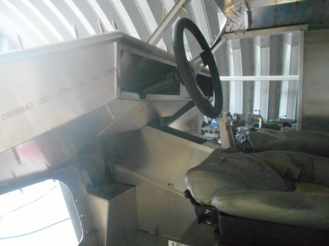 1992 Ford Bronco - Interior view of a vehicle's dashboard and steering wheel, with visible text on the metal panel.