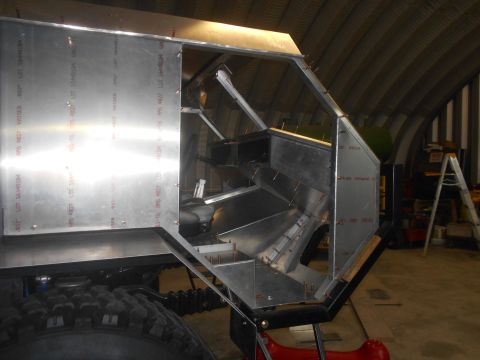 1992 Ford Bronco - Custom aluminum body construction underway, with visible framing and a large off-road tire.
