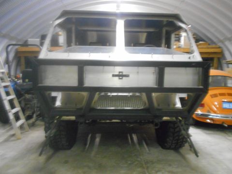 1992 Ford Bronco - Custom off-road vehicle under construction, with an orange Volkswagen Beetle visible in the background.