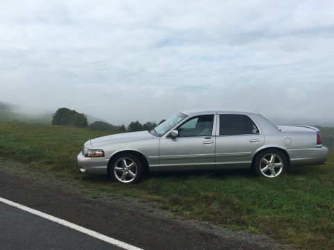2003 Mercury Marauder - Silver 2003 Mercury Marauder parked on the side of a road with a misty landscape behind it.