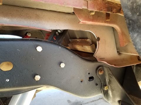 1995 Ford Bronco - Detail of a vehicle's undercarriage, showing frame and suspension components with signs of rust and wear.