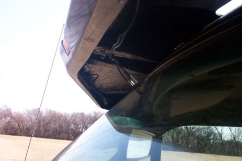 1995 Ford Bronco - View of the interior rear hatch and roof of a vehicle, with wiring visible.