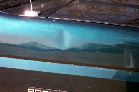 1995 Ford Bronco - Dent on the side body panel of a vehicle.