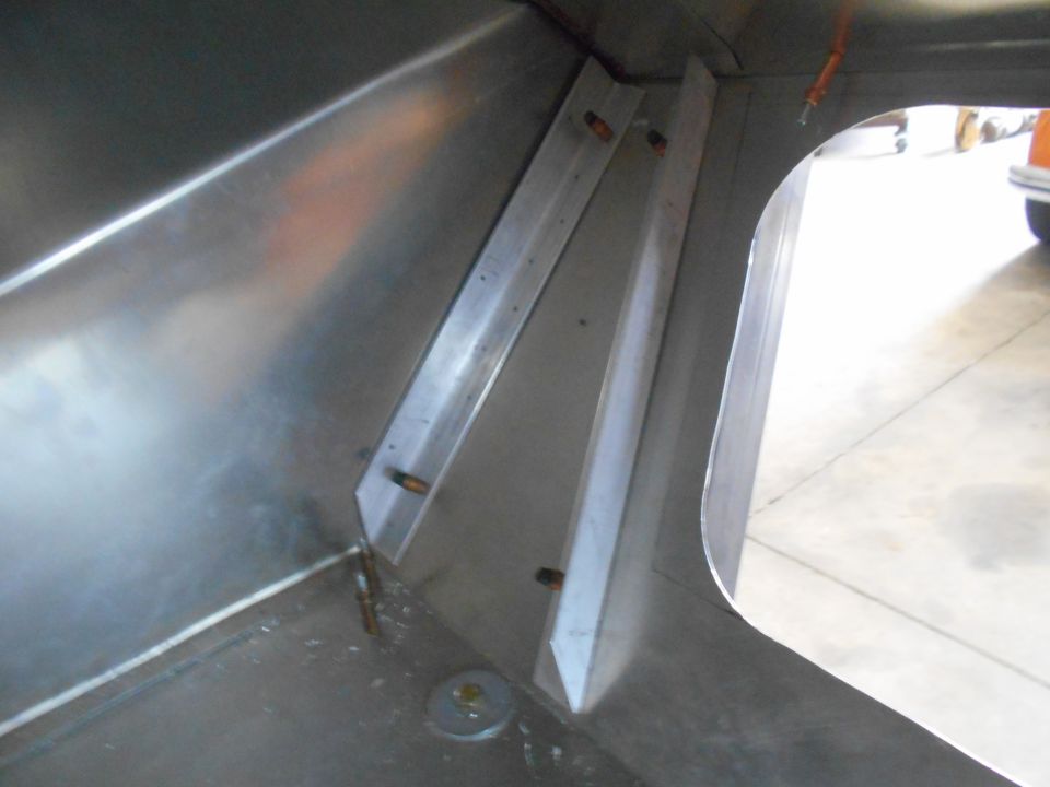 close-up of aluminum paneling and metal brackets inside a vehicle